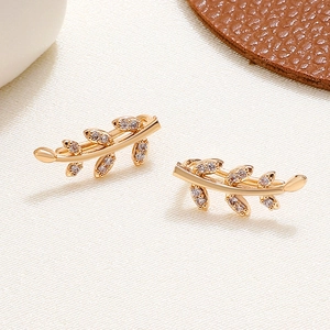 Elegant gold leaf earrings set with sparkling zircons in minimalist olive branch design