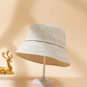 Minimalist cream-beige bucket hat featuring textured geometric jacquard fabric for women