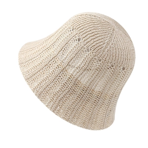 Elegant cream white knit bucket hat with bow detail and breathable hollow weave design