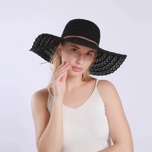 Detail of black lace sun hat showing breathable hollow weave and brown leather cord