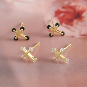 Elegant 18k gold plated cross stud earrings with black and clear crystals on pink background