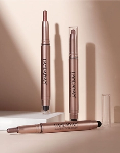 Detailed view of dual-ended eyeshadow sticks with creamy texture and sponge brush tip