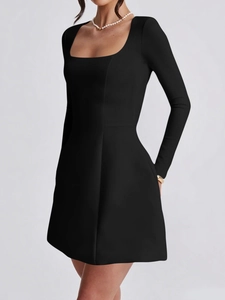 Detail of elegant black long sleeve mini dress featuring a modern square neckline
