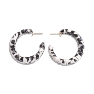 Minimalist C-shape hoop earrings with black and white striped leather wrapping and gold pins