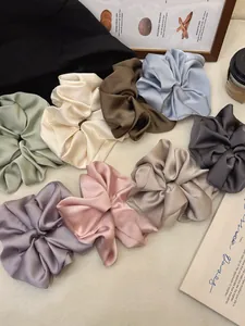 Detailed group view of oversized satin scrunchies in eight elegant Morandi colors