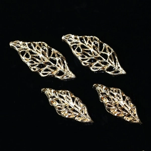 Golden hollow leaf charms for DIY bridal headpiece making on a black background