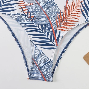 Detail view of white high-waist bikini bottom with tropical palm leaf prints and neat stitching