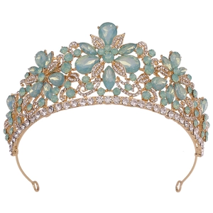 Detailed view of floral gold bridal crown with opal blue crystals and white rhinestones
