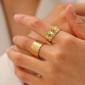Detail of 18K gold-plated stainless steel wide bands featuring a hammered texture finish