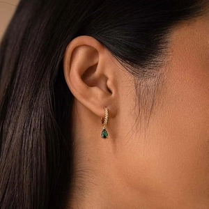 Elegant gold earrings with emerald green teardrop pendant and cubic zirconia pavé