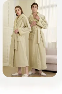 Detailed view of thick beige coral fleece bathrobe with plush trim and waist belt