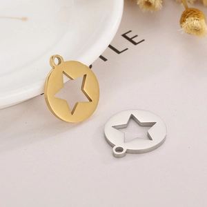 Macro detail of polished stainless steel round pendant with hollow star cutout