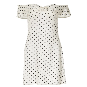 Detail of sweetheart neckline with twist knot and black polka dots on white dress
