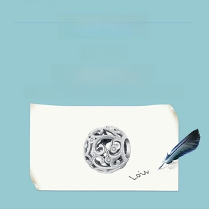 Macro detail of a hollow silver floral charm with vintage filigree patterns on sketch paper