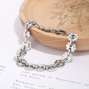 Detailed macro view of silver steel gear link bracelet with lobster clasp and extension