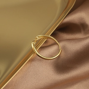 Macro view of gold plated S925 sterling silver twisted ring on metallic tray