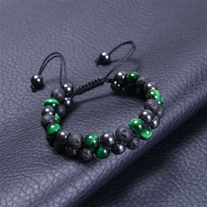Detail of blue tiger eye and lava stone beads on double-layer woven mens bracelet
