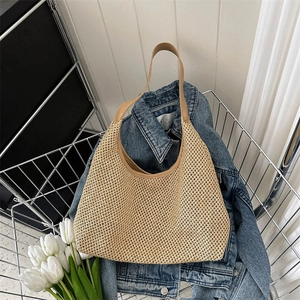 Retro woven straw tote bag with brown leather handles placed in a metal shopping cart