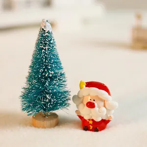 Miniature Santa Claus and frosted Christmas tree figurine for holiday desktop decor