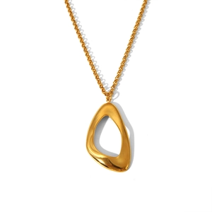 Detailed view of an irregular oval gold pendant on a thin link chain for women