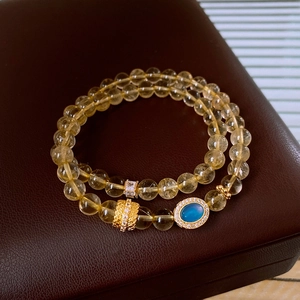 Close-up of double-layer beaded bracelet with yellow citrine beads and gold-plated accents