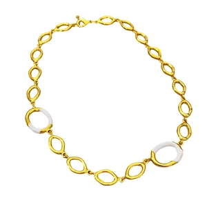 Golden necklace with oval links and white enamel inlay on a clean white background