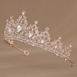 Detailed view of rose gold bridal tiara featuring teardrop and round clear crystals