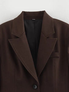Close-up of dark brown blazer with single-breasted notch lapel and fine twill texture