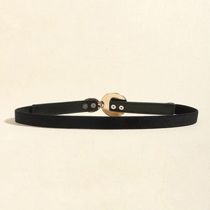 Detail shot of black elastic skinny belt with a polished gold round metal buckle