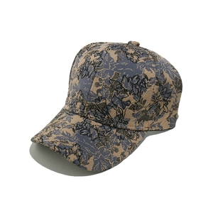 Detail view of vintage jacquard baseball cap with blue and beige floral patterns