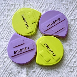 Close-up of four water-drop makeup sponges in yellow and purple with SISSIMU logo