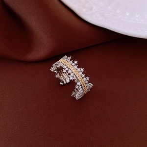 Detailed macro shot of a wide mixed-metal star ring with pavé zircons and crown edge