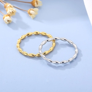 Detail of minimalist gold and silver beaded stackable rings with glossy finish