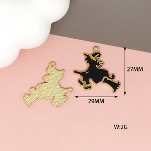 Detail shot of Halloween witch hat enamel pendants showing front design and back texture