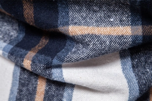 Close-up of premium plaid flannel fabric with blue and white interwoven checkered pattern