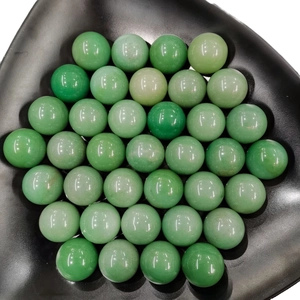Polished 25mm green aventurine crystal spheres arranged in a black triangular tray