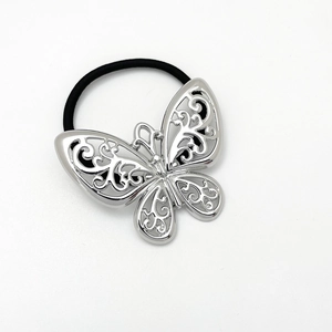 Detail of silver hollow butterfly metal hair tie with polished finish and elastic band