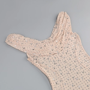 Close-up of sparkling rhinestones on nude mesh dress fabric with side zipper detail