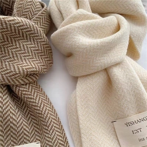 Détail d'écharpes en tricot à chevrons marron et crème avec texture douce