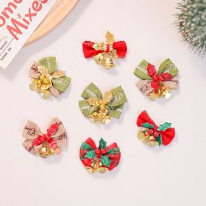 Macro view of seven assorted Christmas linen bows with bells and festive pine needles