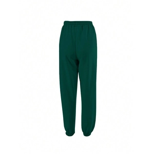 Detail of dark green sweatpants featuring elastic waistband and drawstring design