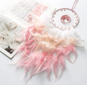Detail of pink and white gradient feathers on the handmade tree of life dreamcatcher