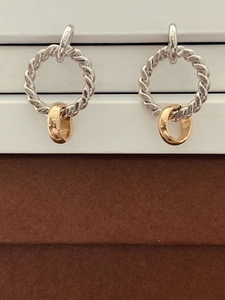 Minimalist S925 silver twist hoop earrings with gold pendant on a white platform