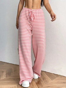 Close-up of pink and white striped knit trousers with drawstring waist and ribbed texture