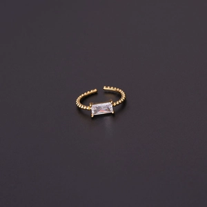 Macro shot of adjustable gold ring featuring a rectangle cut clear zircon center stone