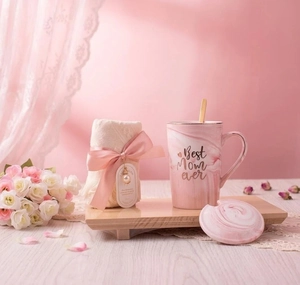 Detail of pink marble ceramic mug with Best Mom ever gold script and ribboned towel
