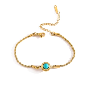 Macro view of gold-plated stainless steel rope chain bracelet with turquoise stone inlay
