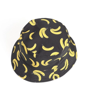 Top-down view of black cotton bucket hat with vibrant yellow banana pattern print