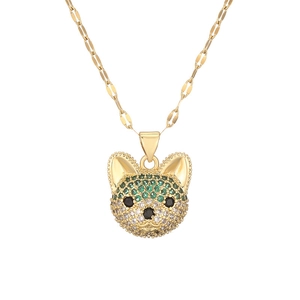 Close-up of golden Shiba Inu pendant with sparkling crystals on flat gold chain