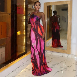 Sleeveless backless maxi dress with vibrant abstract print and halter neck design
